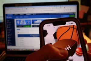 a cellphone with sports betting website on the screen