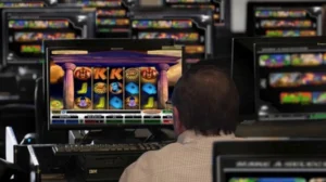 a man playing sweepstakes casino slot at home